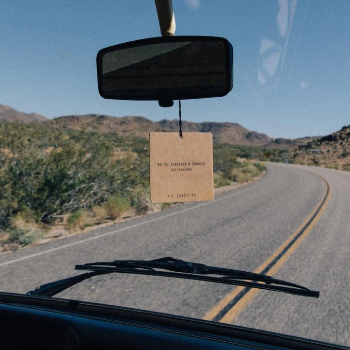 Square Car Freshener hanging from a rearview mirror in a car